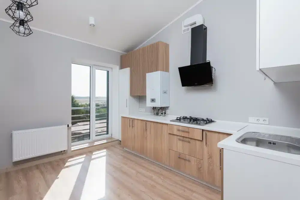 Open aluminium awning window providing natural ventilation inside an Australian home