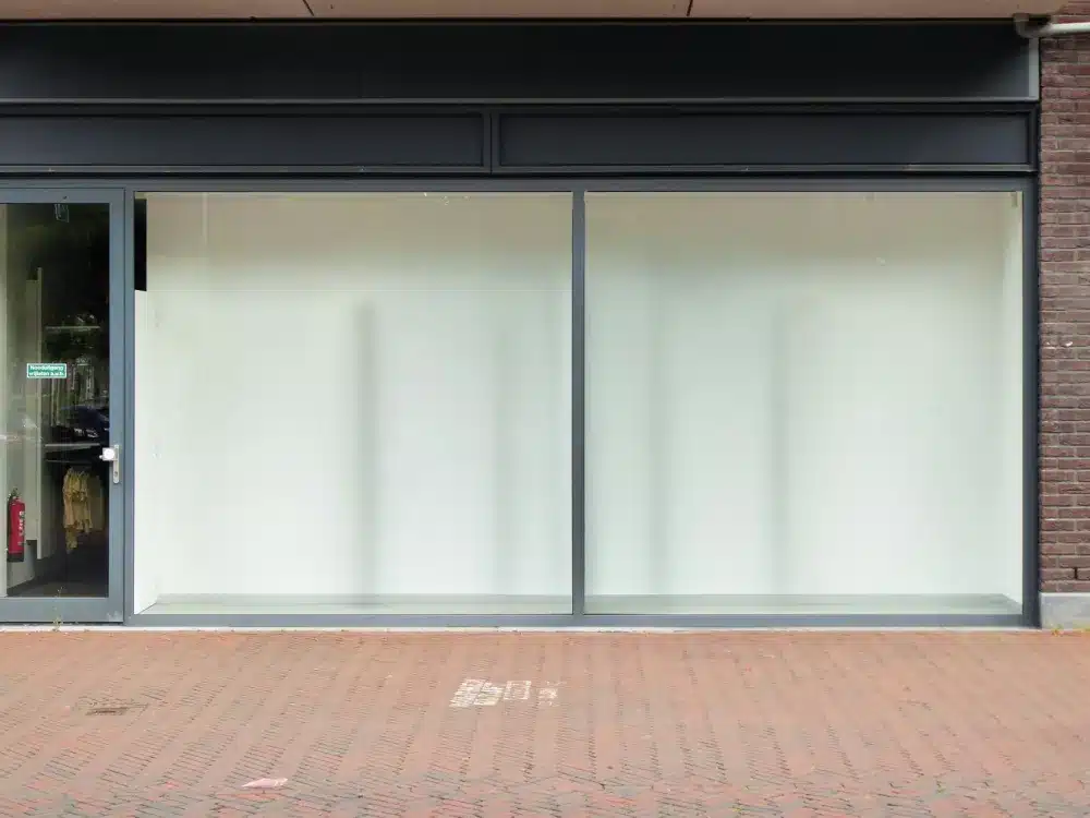 Toughened vs Laminated Glass: Which Do You Need? 1 Modern glass shopfront with aluminium framing on a commercial building in NSW