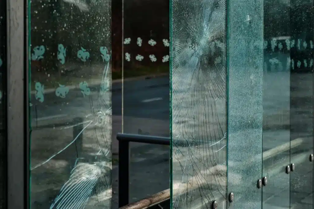 Glazier installing toughened vs laminated glass panel in aluminium window frame