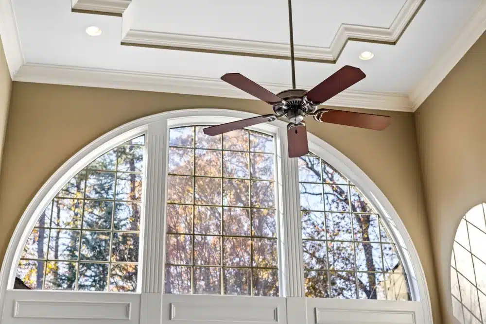 Awning vs fixed windows: Open aluminium awning window providing ventilation inside a bright living room