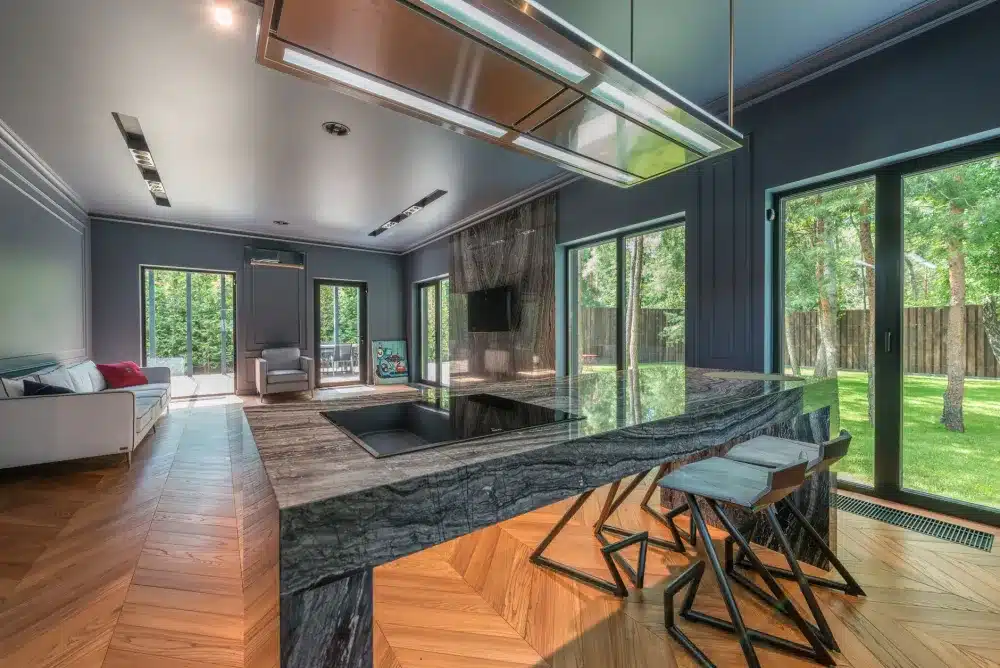 Awning vs Sliding Windows: How to Choose 2 Wide aluminium sliding window in bright living room with garden view