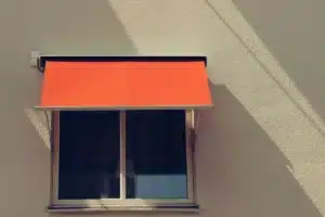 Side-by-side aluminium awning and sliding windows on a modern Australian home exterior