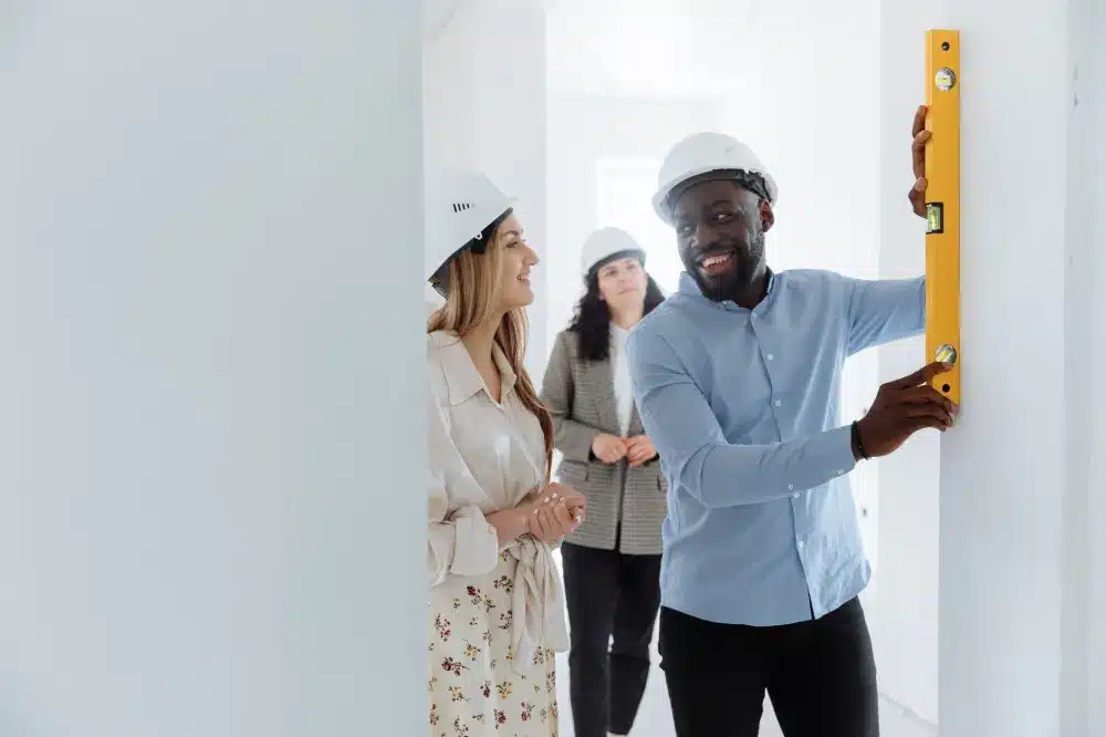 Tradesperson measuring an aluminium door opening for a free measure and quote