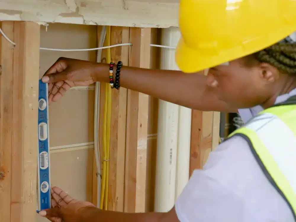 Tradesperson measuring aluminium sliding door frame during a free measure and quote visit