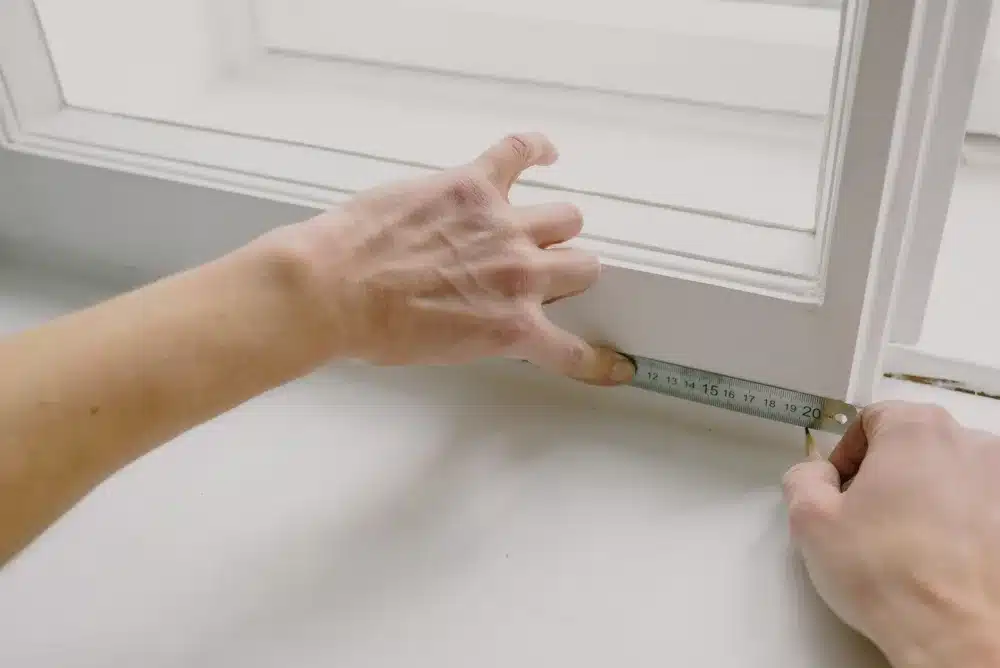 Double Hung vs Sliding Windows for Your Home 4 Professional window installer measuring aluminium window frame for replacement in Camden NSW