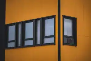 Cross-section diagram comparing low-E glass and double glazing in aluminium window frames