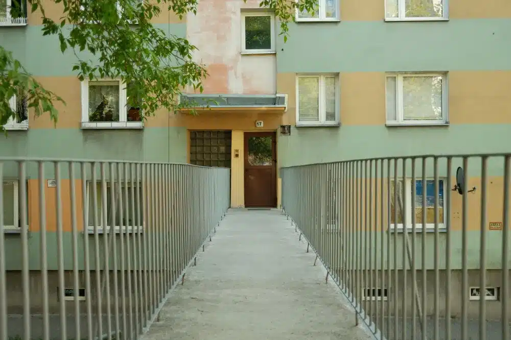 Shopfront Doors vs Apartment Entry Doors: The Differences 2 Modern aluminium entry door on a multi-storey apartment building exterior
