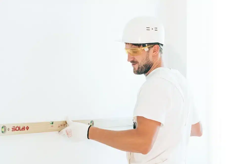 Professional glazier installing glass office partitions in an Ingleburn commercial building